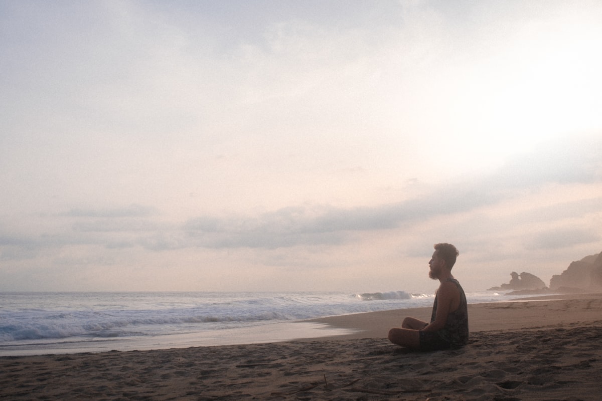 Man practicing morning wellness routine with meditation and exercise